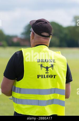 NIJVERDAL, NETHERLANDS - JUNE 23, 2018: Professional drone pilot controling a drone with camera Stock Photo