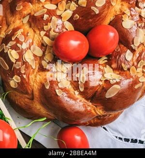 Easter traditional sweet bread, greek tsoureki and red eggs closeup view. Orthodox Christian Easter tradition Stock Photo