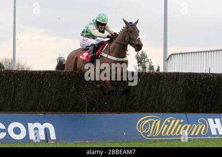 Kie ridden by Henry Brooke in jumping action in the Racing Plus Chase Day 230212 Handicap Chase - Horse Racing at Kempton Park Racecourse Stock Photo