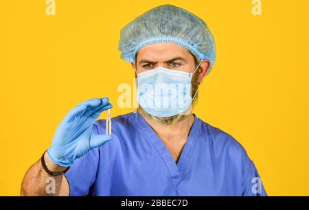 making virus test. developed vaccines. source of outbreak of new coronavirus in China. How virus is transmitted. health worker wear mask while research test tube in lab. more radical measures. Stock Photo