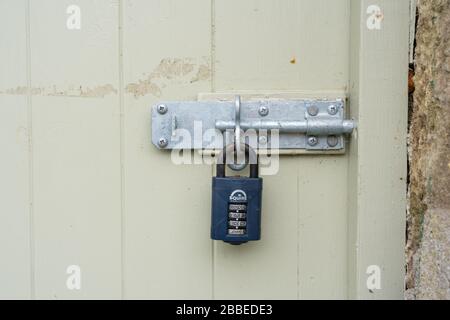 Combination padlock on old door in Newport, Pembrokeshire. Wales. UK Stock Photo