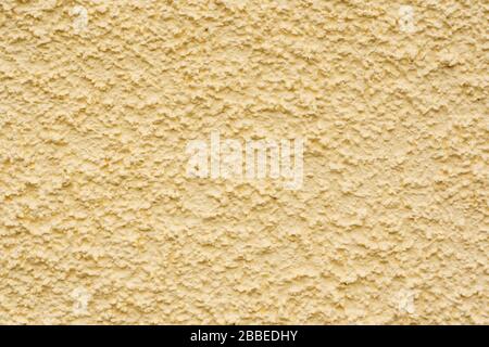 Close up of cream coloured rough cast wall render background. Newport, Pembrokeshire, Wales. UK Stock Photo