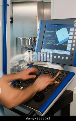Technician working with a milling machine Stock Photo