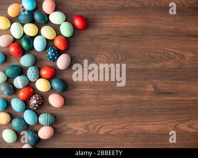 Colorful Easter eggs on wooden table. Easter holiday decorations , Easter concept background. Stock Photo