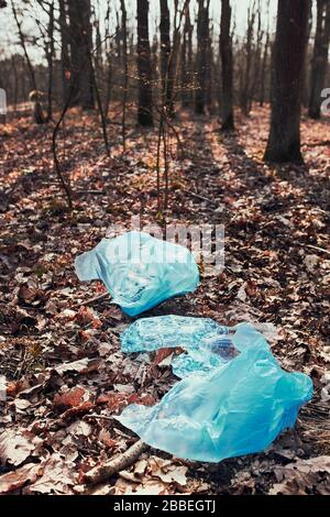 Plastic waste left in forest. Concept of plastic pollution and irresponsibility for environment. Environmental issue. Environmental damage Stock Photo