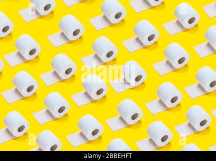 lots of toilet rolls on a yellow background