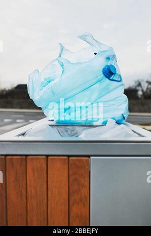 Plastic bag full of plastic waste put on outdoor trash. Plastic waste to recycling. Concept of plastic pollution and recycling plastic waste. Environm Stock Photo