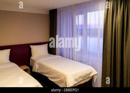 Hotel room with two double beds with pillows Stock Photo