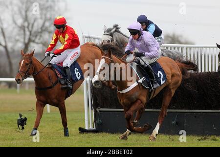 Race winner Tetlami ridden by Barry Geraghty (R) in jumping action ahead of Jackies Solitaire ridden by Noel Fehily in the Huntingdon Racecourse Novic Stock Photo