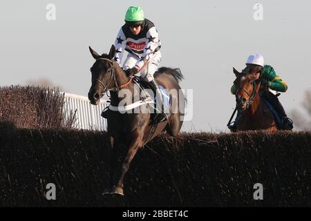 Race winner Owen Glendower ridden by Barry Geraghty in jumping action during the Weatherbys Cheltenham Festival Betting Guide Novices Chase Stock Photo