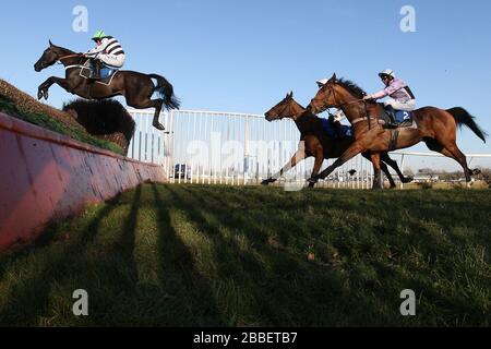 Race winner Owen Glendower ridden by Barry Geraghty in jumping action during the Weatherbys Cheltenham Festival Betting Guide Novices Chase Stock Photo