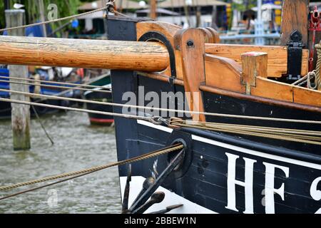 Close up of the bow section of a historic sailing ship in Hamburg harbor with wooden bowsprit and anchor visible Stock Photo