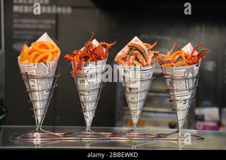 Madrid, Spain: Close up view of four paper cones filled with various fried seafood in a Spanish tapas restaurant Stock Photo