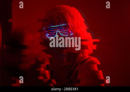 Girl with blaster in the futuristic battle. Concept virtual reality, cyber game and science fiction. Image with glitch effect. Stock Photo