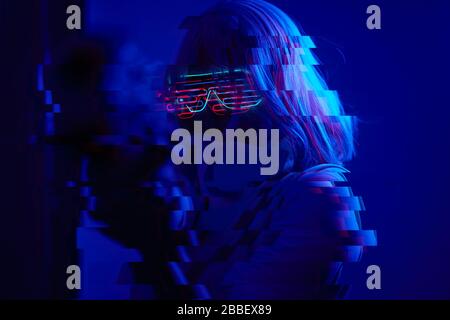 Girl with blaster in the futuristic battle. Concept virtual reality, cyber game and science fiction. Image with glitch effect. Stock Photo