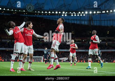 LONDON, ENGLAND - FEBRUARY 23: Pierre-Emerick Aubameyang of Arsenal FC celebrate with heÕs team mates Nicolas Pepe, Hctor Bellerin after scoring heÕs Stock Photo