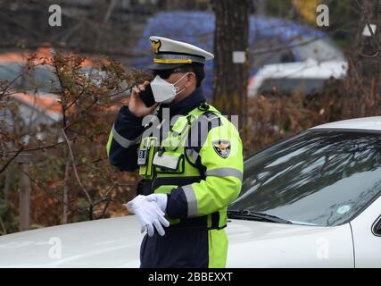 Korean police officer using facial protective mask similar to those used during the epidemic Coronavirus (COVID-19) outbreak in China and Korea. Stock Photo