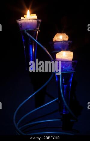 Lite Candles against a black background taken using candle light and a small torch, Northampton, England, UK. Stock Photo