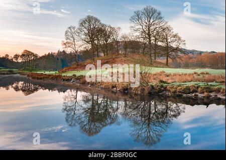 Tranquil woodland & fells landscape at Elter water a small lake / tarn near Elterwater in Great Langdale in the English Lake District, Cumbria Stock Photo
