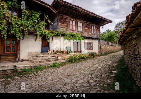Free roam chickens on the cobbled streets of village Zheravna Bulgaria Stock Photo