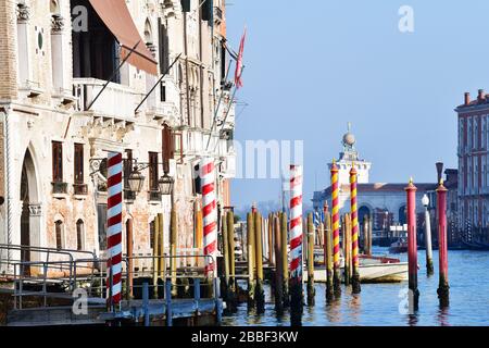 Venice, Italy-February 2020; high level view over Canal Grande in the direction Punta della Dogana with some nice colored poles (pali da casada) Stock Photo