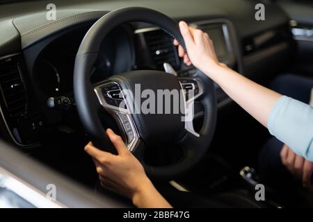 Man and woman in a car dealership, buying a car, buyers and sellers Stock Photo