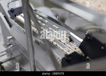 pill making anti virus viral machine mass produced cover-19 corona Stock Photo