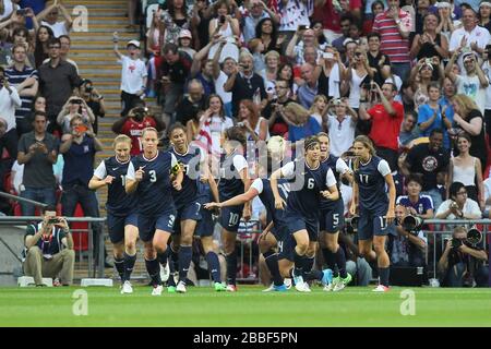 Carli LLOYD of USA scores the first goal and celebrates with her team mates during the Final of the London 2012 Olympics Women's Football Tournament Stock Photo