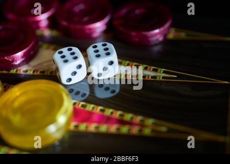 A closeup of a colorful Backgammon with dice showing double six on it on the table Stock Photo