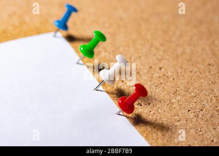 colourful pushpin stuck in the cork board in the background Stock Photo