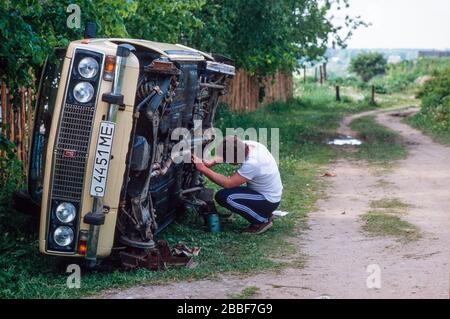 A man working on his Lada car, in town of Sergiyev Posad, formally Zagorsk, 70 km from Moscow. Stock Photo