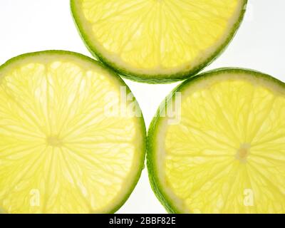 Three lime slices on a white background Stock Photo