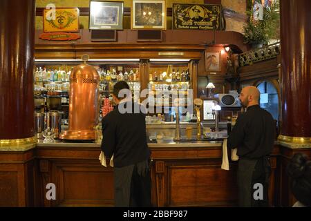 Buenos Aires, Argentina: View on two of the waiters of cafe Tortoni getting the orders ready for the customers standing at the tradition Stock Photo