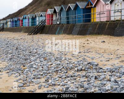 Beach huts along the top of Cromer beach, Norfolk, UK Stock Photo