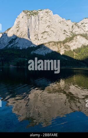 Trisselwand mountain in late afternoon springtime reflecting in Altaussee lake, Altaussee, Styria, Salzkammergut, Austria Stock Photo