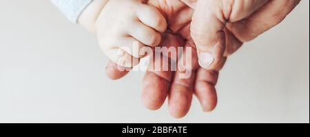 An old woman and a kid holding hands together Stock Photo