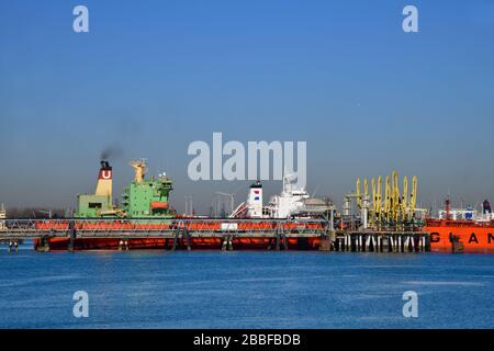 Side view of a docked Chemical and Oil Products Tanker in the 7th petroleum harbor with a tank farm in the back Stock Photo