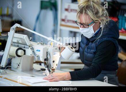 Wendisch Waren, Germany. 31st Mar, 2020. Employee Daniela Grunow sews masks for protection against corona viruses in the Ber-Bek company. The company normally produces chef's jackets and clothing for restaurant kitchens and switched production to protective masks a few days ago. Masks of different sizes and colours are sewn according to customer orders. Credit: Jens Büttner/dpa-Zentralbild/dpa/Alamy Live News Stock Photo