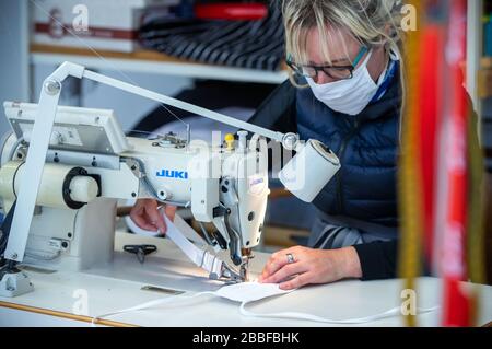 Wendisch Waren, Germany. 31st Mar, 2020. Employee Daniela Grunow sews masks for protection against corona viruses in the Ber-Bek company. The company normally produces chef's jackets and clothing for restaurant kitchens and switched production to protective masks a few days ago. Masks of different sizes and colours are sewn according to customer orders. Credit: Jens Büttner/dpa-Zentralbild/dpa/Alamy Live News Stock Photo