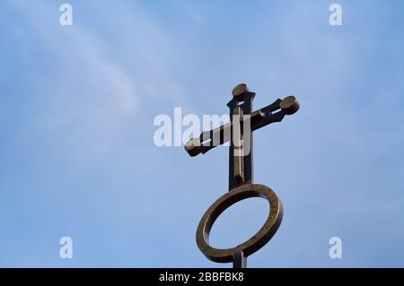 Forged christian cross against the sky Stock Photo