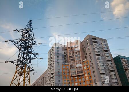 High-voltage networks, residential buildings against the evening sky Stock Photo