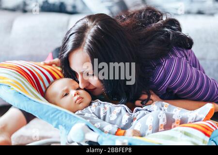 beautiful mother with newborn cute baby at home Stock Photo