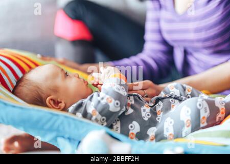 beautiful mother with newborn cute baby at home Stock Photo