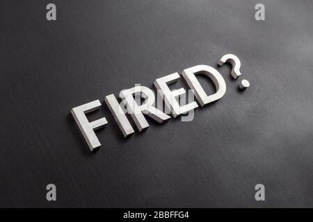 the question fired laid with white brushed metal letters on flat black surface in diagonal perspective with selective focus and background blur Stock Photo