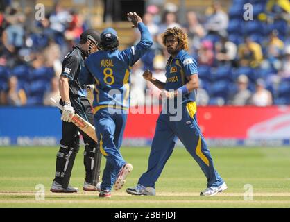 Sri Lanka's Lasith Malinga (right) is congratulated by his team mate Kusal Perera after taking the wicket of New Zealand's Kane Williamson (left) during the ICC Champions Trophy match at the SWALEC Stadium, Cardiff. Stock Photo