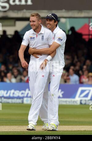 England's Stuart Broad (left) is congratulated by Steven Finn after taking the wicket of New Zealand's Tim Southee for 7 during the first test at Lord's Cricket Ground, London. P Stock Photo