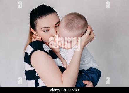 Crying toddler girl being consoled by her mother Stock Photo