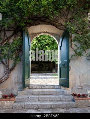 green open gate to walled garden in historic Tuscan Villa, Italy Stock Photo