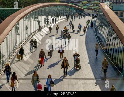 The busy footbridge over the railway line that takes shoppers and from Stratford train station to Westfield shopping center Stock Photo