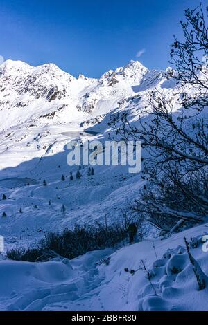 The mountains of Tartano Valley, near the town of Morbegno, Italy, during a beautiful winter day Stock Photo